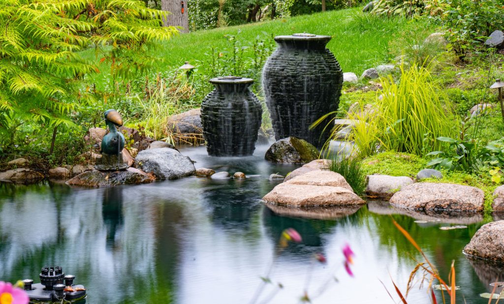 Water fountains on edge of koi pond addition